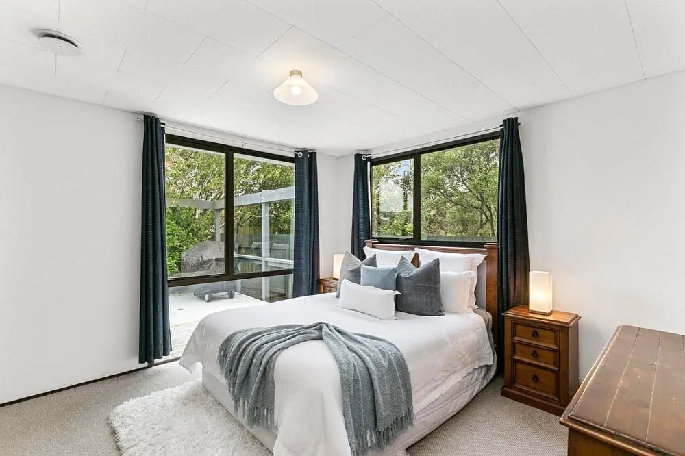 Bright finished bedroom with crisp white painted walls and ceiling